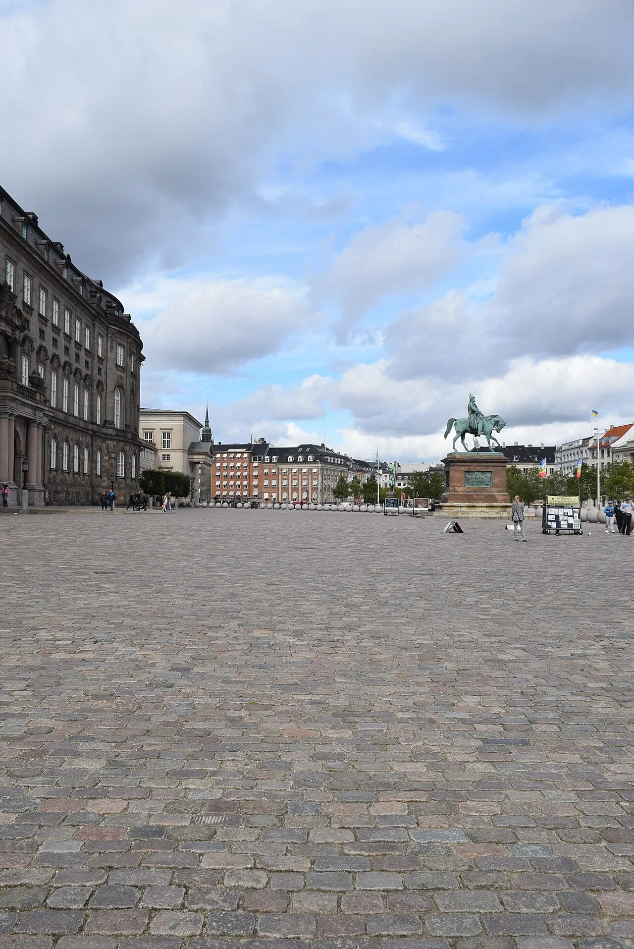 A striking view of the iconic Danish Parliament Building, Christiansborg Palace, overlooking Copenhagen's harbor.