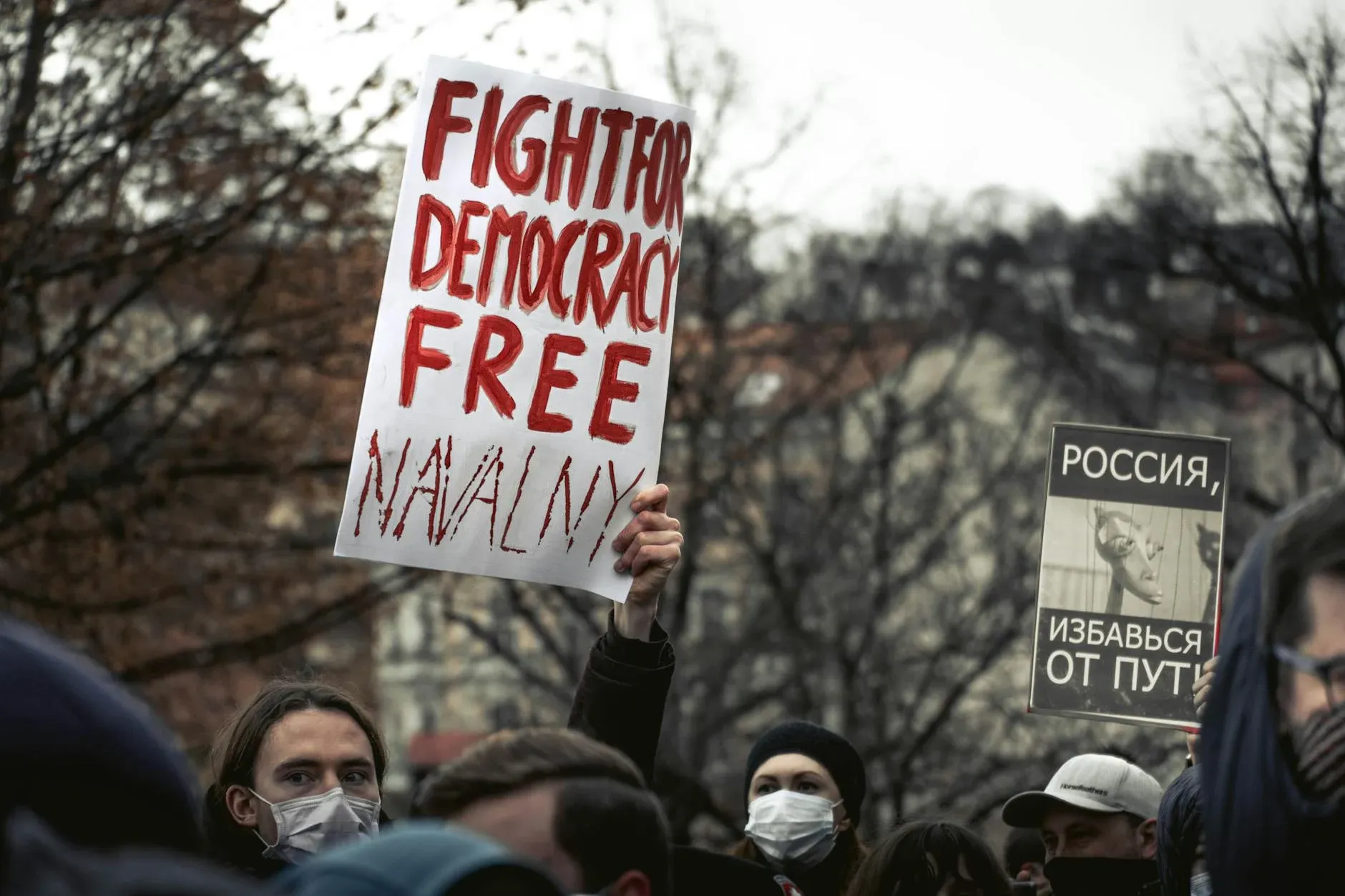 Demonstrators in Prague hold signs demanding political reform and democratic rights.