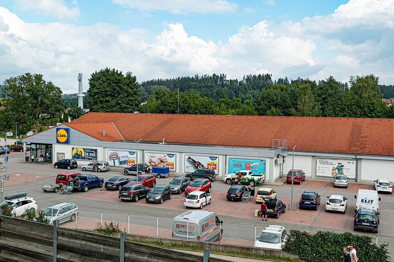 A vibrant supermarket scene in Nové Pace, Czech Republic, showcasing the interior layout and products.