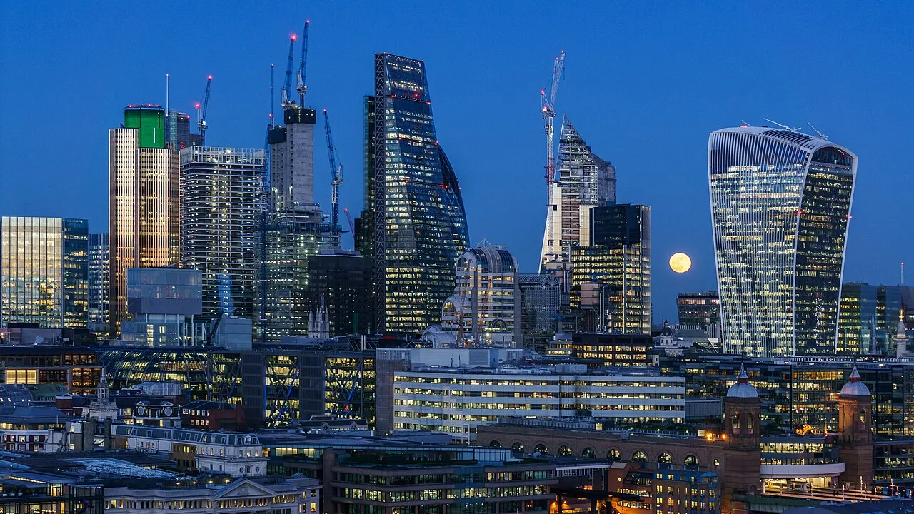 A stunning view of the supermoon over the City of London from the Tate Modern, capturing the celestial event against the urban skyline.
