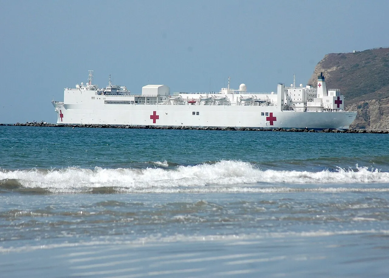 The USNS Mercy (T-AH-19) prepares to depart San Diego Bay, marking the start of its humanitarian mission.