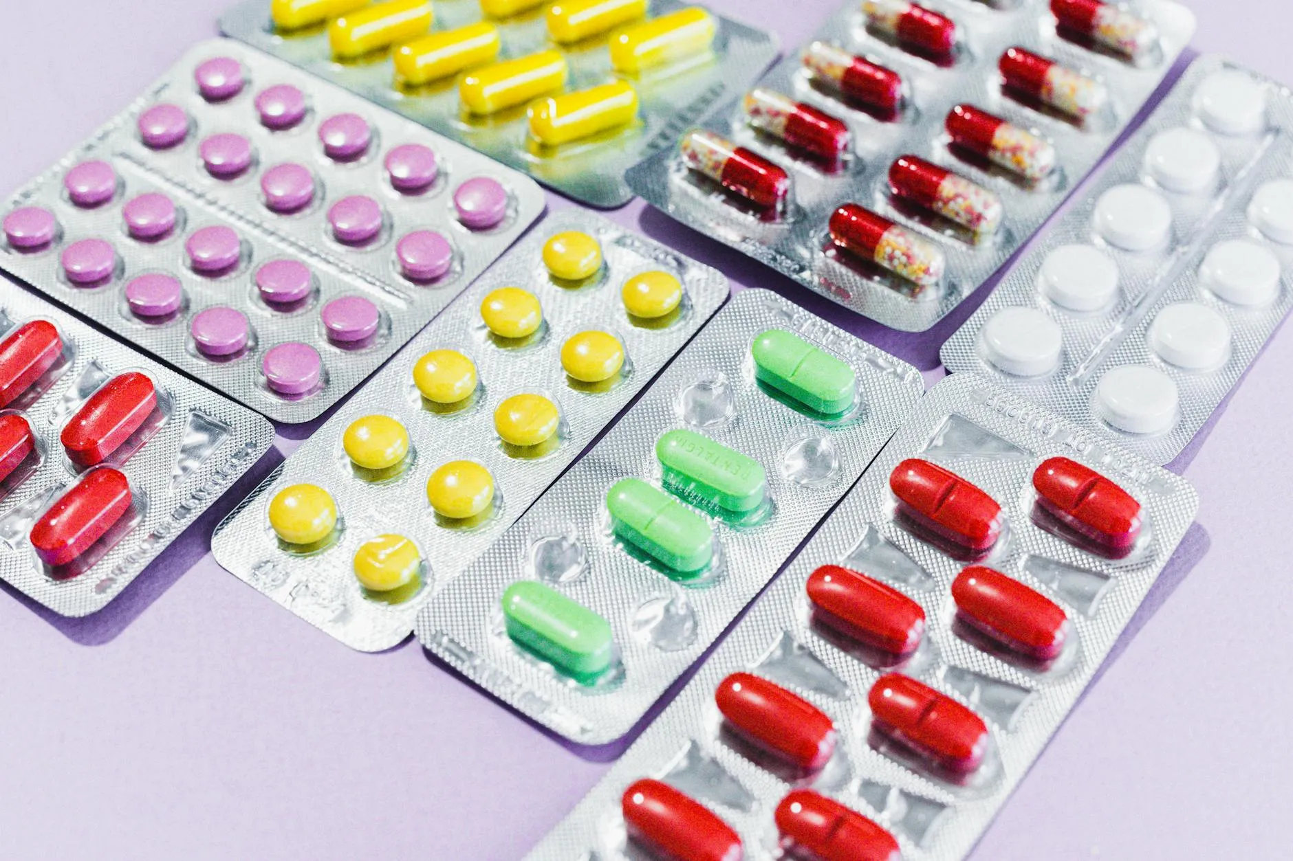A close-up view of various colorful pills in blister packs, highlighting different medicine types.