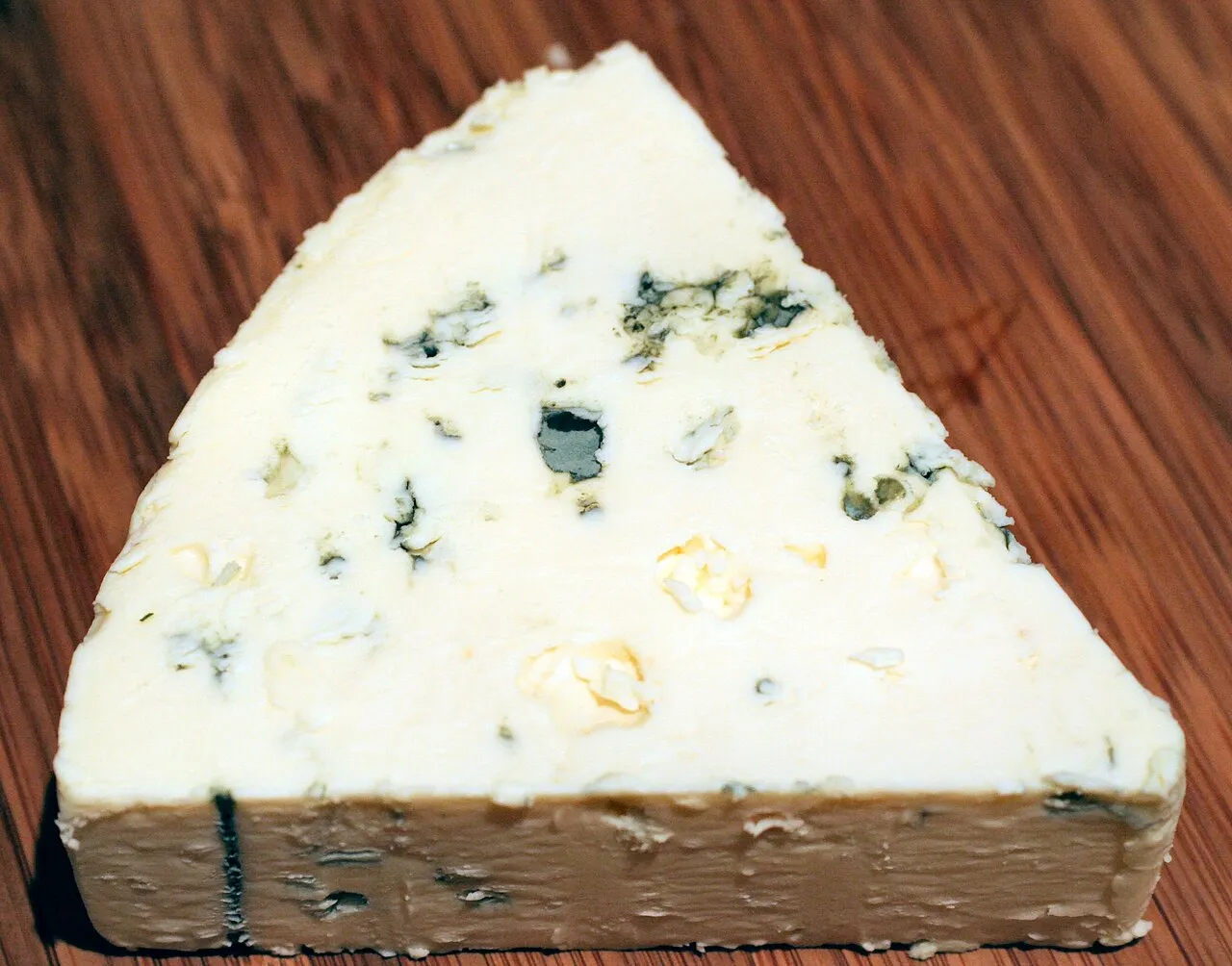A close-up of Danish Blue cheese with distinct blue veins, showcasing its creamy texture and rich flavor.