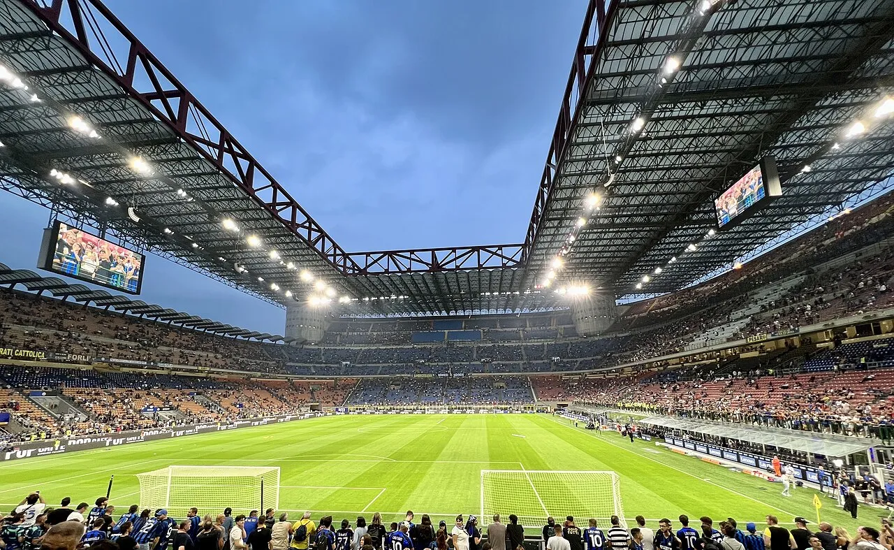Aerial view of the iconic Giuseppe Meazza Stadium in Milan, Italy, during a football match.