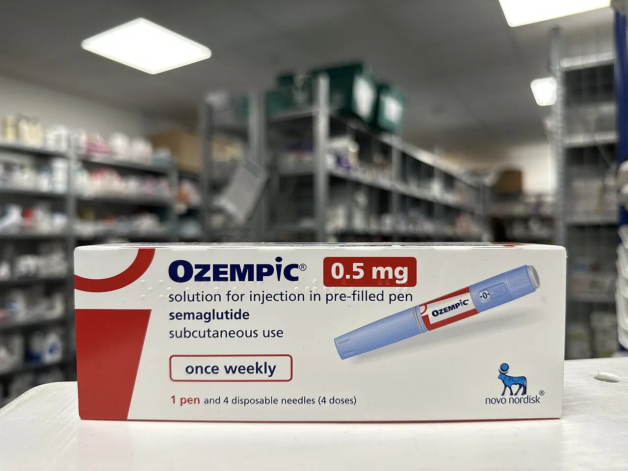 A close-up of a pharmacy box for Ozempic (Semaglutide 0.5mg), a medication used for weight management.