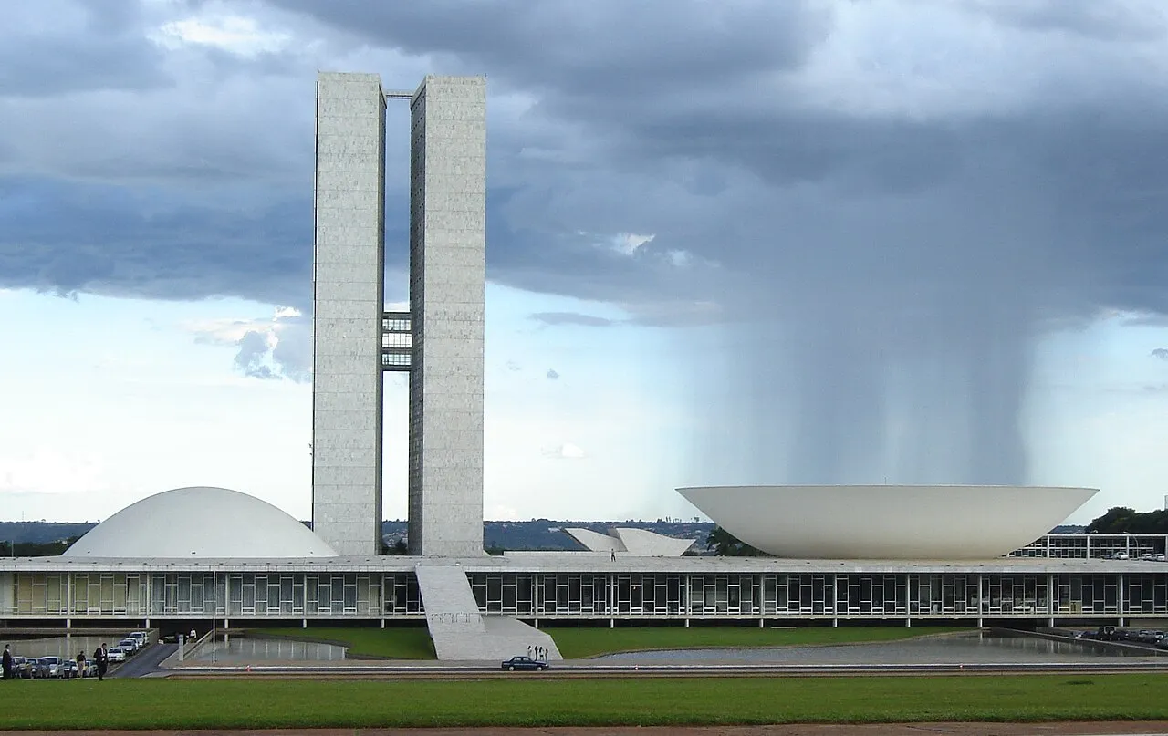 Brasiliens nationalkongres ses i baggrunden med regn i luften. Den ikoniske arkitektur er tegnet af Oscar Niemeyer.