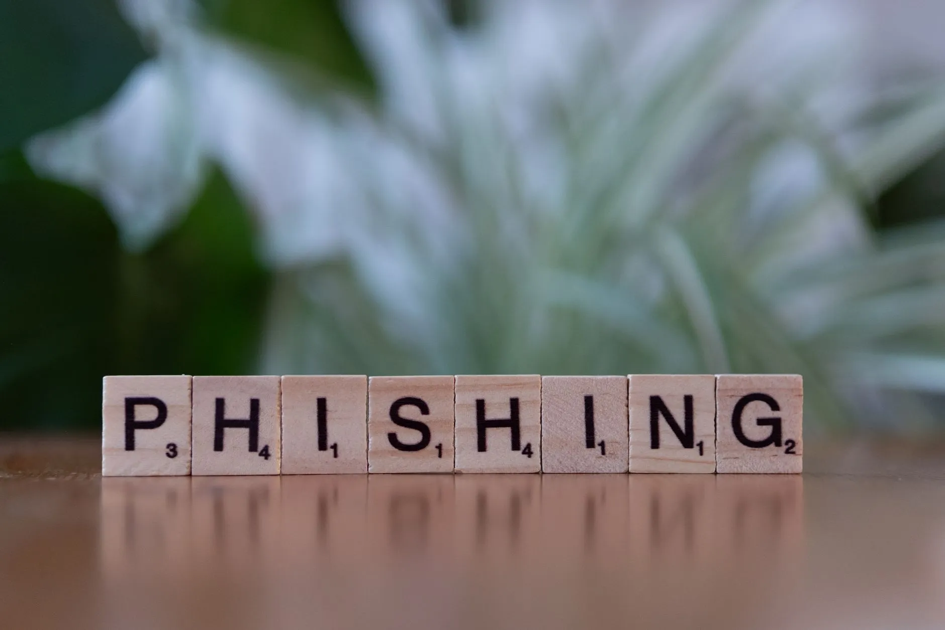 Træfliser danner ordet “phishing” og illustrerer cybersecurity-temaer. Billedet formidler risikoen ved phishing-angreb på en visuel og enkel måde.